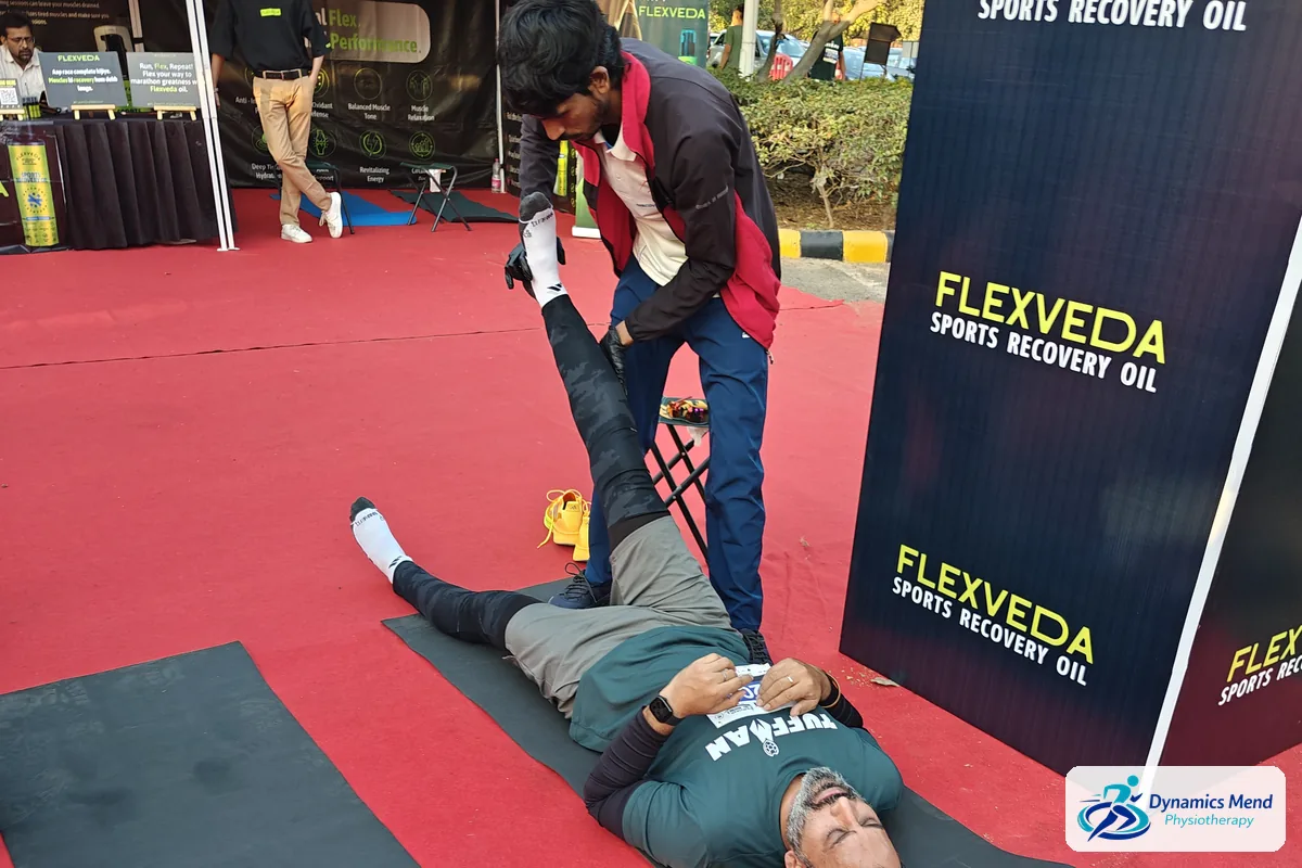 Assisted straight-leg hamstring stretch for a runner at the race recovery zone