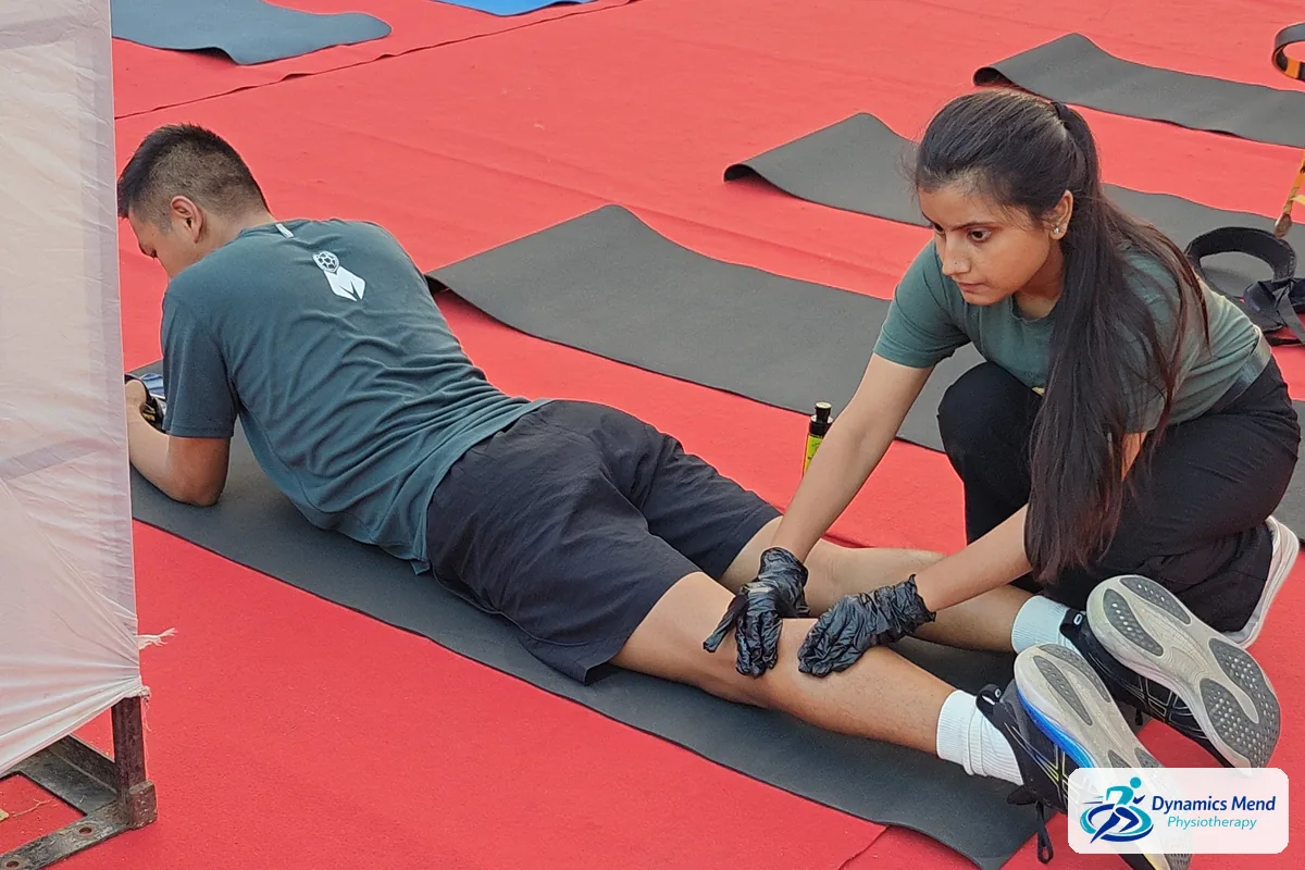 Physiotherapist releasing tight calves for a runner after the half marathon