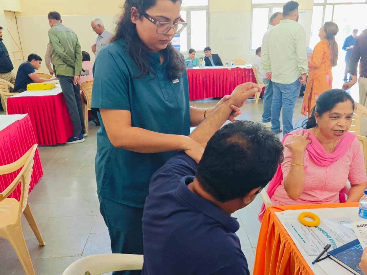 Shoulder movement assessment at a free health camp in Noida